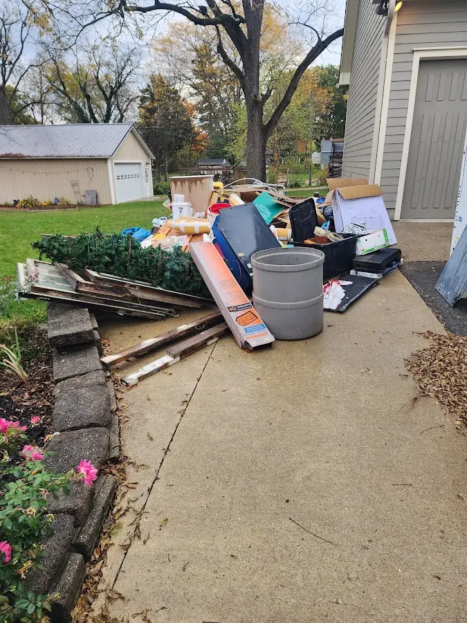 Dumpster being loaded with debris for Estate Cleanout Dumpster Rental in Port Charlotte